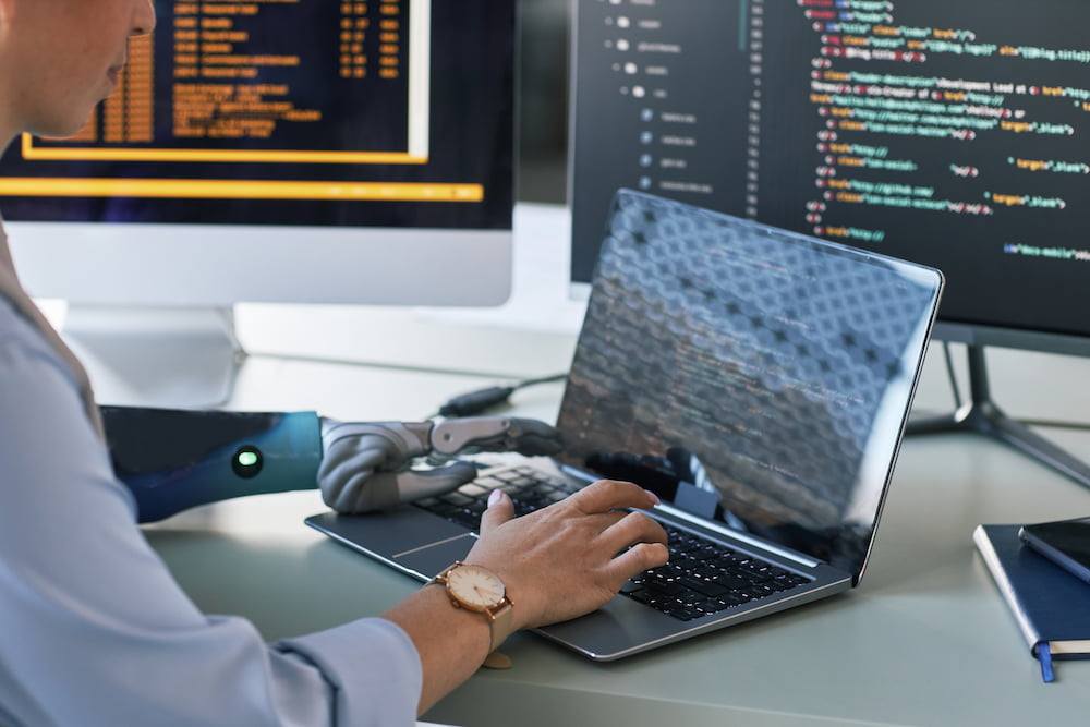 software-engineer-coding-at-desk-with-robotic-arm-2026-01-08-06-46-58-utc