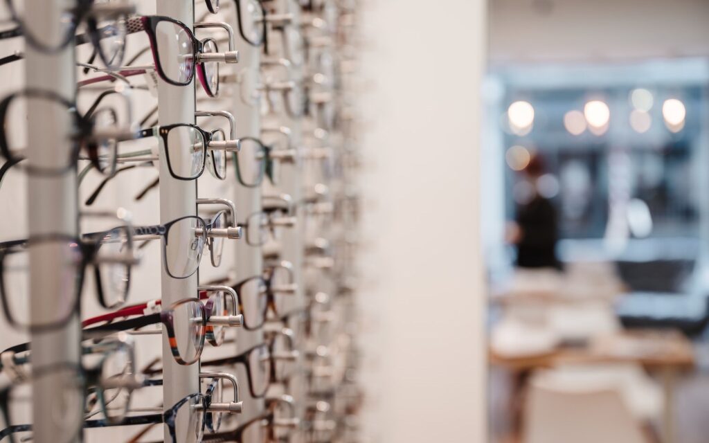 Reading glasses resting on a wooden table
