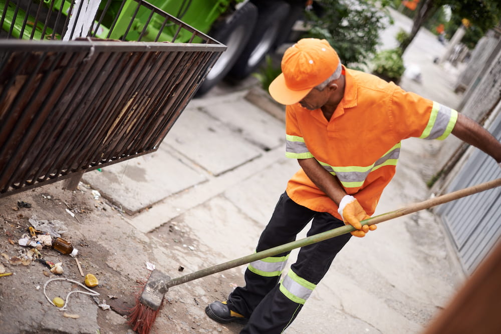man-sweeping-street-with-broom-and-refuse-containe-2026-01-09-09-52-01-utc