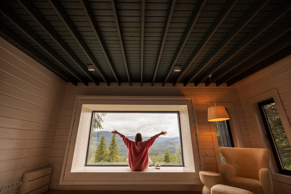 woman-relaxing-at-window-seat-enjoying-mountain-vi-2026-03-20-06-16-51-utc