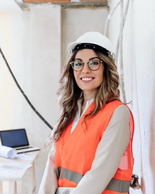 smiling professional confident architect woman in construction site. Home renovation
